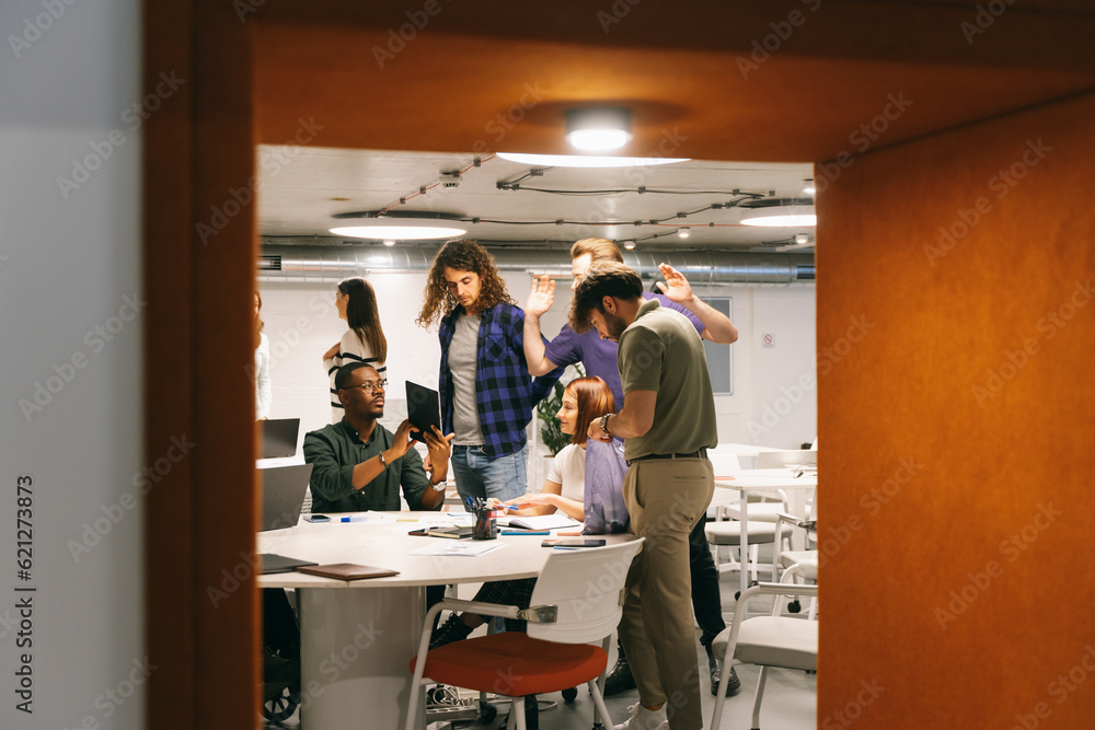 Angry male African company boss showing a big mistake to his employee on the tablet. He is saying that it is not his fault Angry male African company boss showing a big mistake to his employee on the tablet. He is saying that it is not his fault