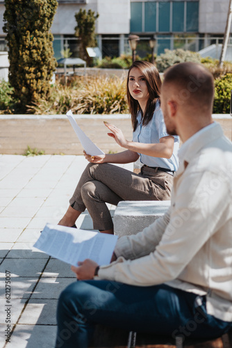 Brunette business person talking to her male partners, giving them advices for better efficiency at work