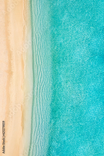 Summer seascape beautiful waves, blue sea water in sunny day. Top view coast. Sea aerial drone view, amazing tropical nature peaceful. Beautiful bright sea calm waves splash. Mediterranean beach sand