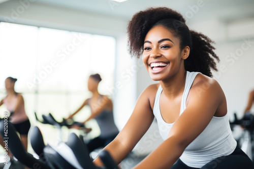 Group fitness class , featuring participants engaged in an energetic workout, such as spinning, aerobics, set against a bright, gym studio background © Jasmina