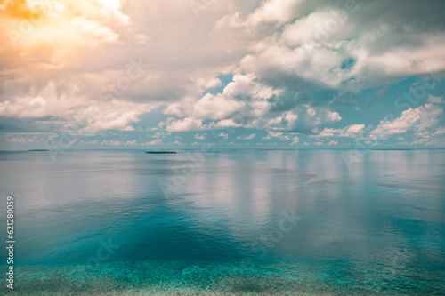 Aerial view of blue sea surface water texture background sun reflections. Aerial flying drone view calm waves water surface texture on sunny tropical ocean. Minimalistic seascape cloudscape skyline © icemanphotos