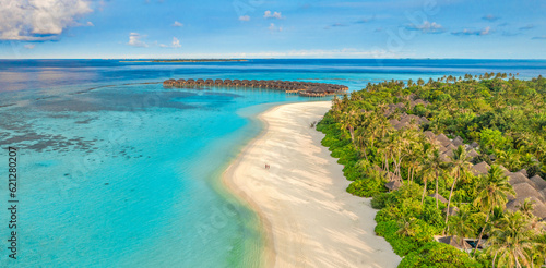 Beautiful amazing Maldives paradise. Fantastic tropical aerial travel landscape, seascape. Luxury water villas bungalows. Dream vacation, best destination aerial drone beach view. Palm trees sea sky