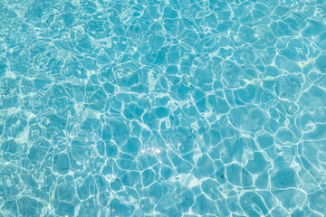 Blue ripped sea water as swimming pool. Crystal clear ocean lagoon bay turquoise blue azure water surface, closeup natural environment. Tropical Mediterranean beach water background