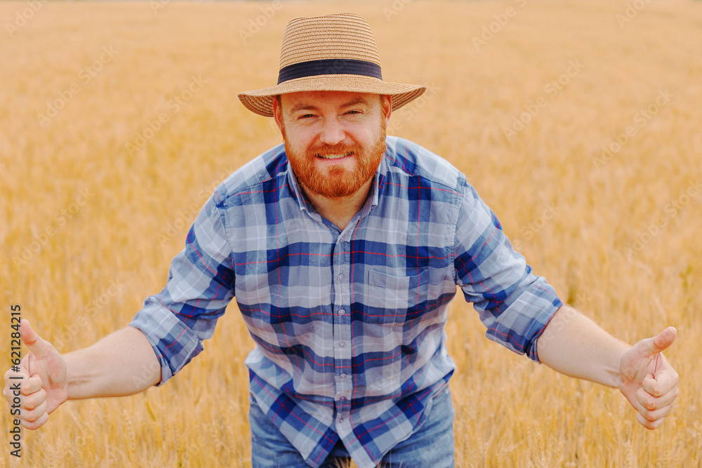 Happy farmer Standing plant in his Wheat field.Peasant farmer standing, cultivating wheat in the field with skill and care. Happy farmer Standing plant in his Wheat field.Peasant farmer standing, cultivating wheat in the field with skill and care.