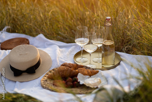 Obraz na płótnie Beautiful summer picnic in the park with tasty fresh berries, croissants, cheese and wine. Pleasure time at nature. w salonie
