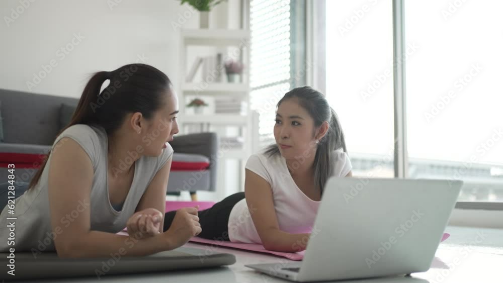 Women play yoga at home. Healthy lifestyle and friendship concept. Women play yoga at home. Healthy lifestyle and friendship concept.