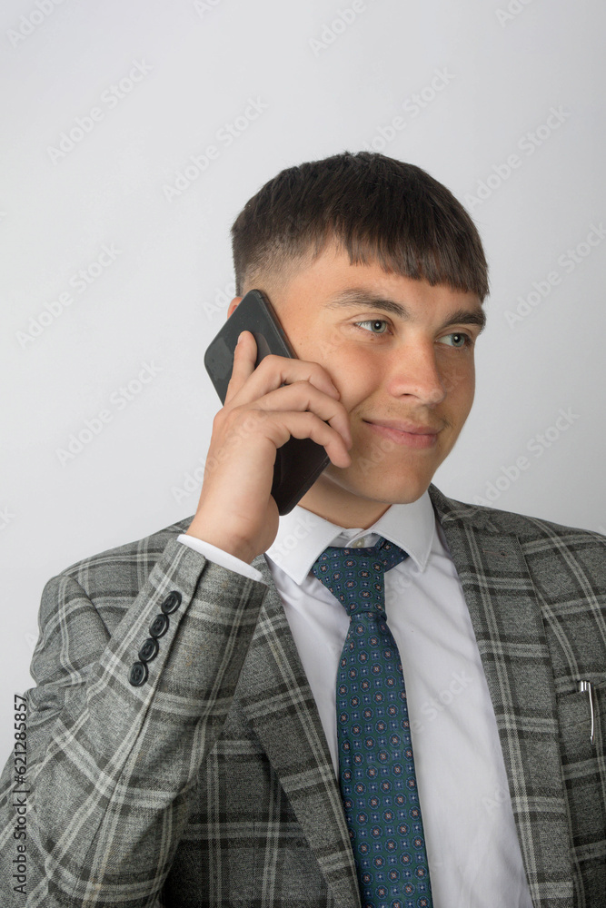 Young entrepreneur wearing a suit and tie making a phone call Young entrepreneur wearing a suit and tie making a phone call
