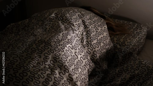 Woman sleeping on her bed in the bedroom.Sleep apnea disease.Girl with sleep disorder.Breathing irregularity.Lady in deep sleep at midnight.Bed sheet pillow night light snore snoring person people awe photo