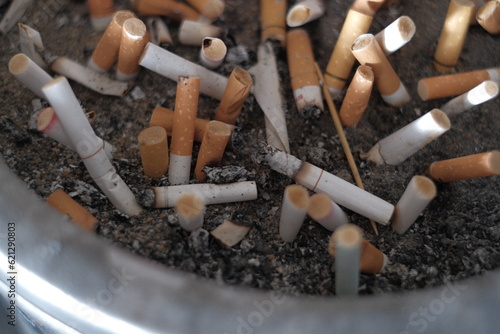 Cigarettes burning in smoking areas