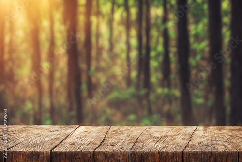 The empty rustic wooden plank table top with blur background of jungle 