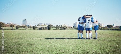 Sports, mockup and a team of soccer players in a huddle on a field for motivation before a game. Football, fitness and training with man friends getting ready for competition on a pitch together © Daniels C/peopleimages.com