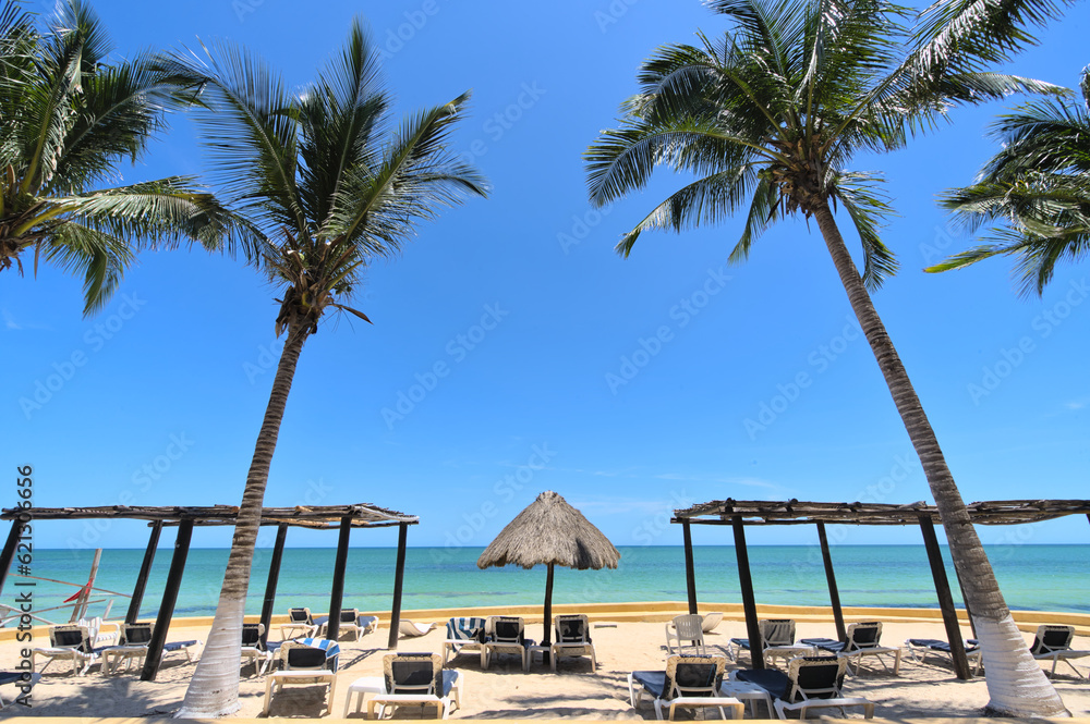 Fototapeta premium Chairs on a sand beach and horizon (Merida, Yucatan, Mexico)