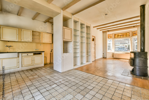 an empty kitchen and stove in a room with tile flooring on the floor, there is a wood burning stove