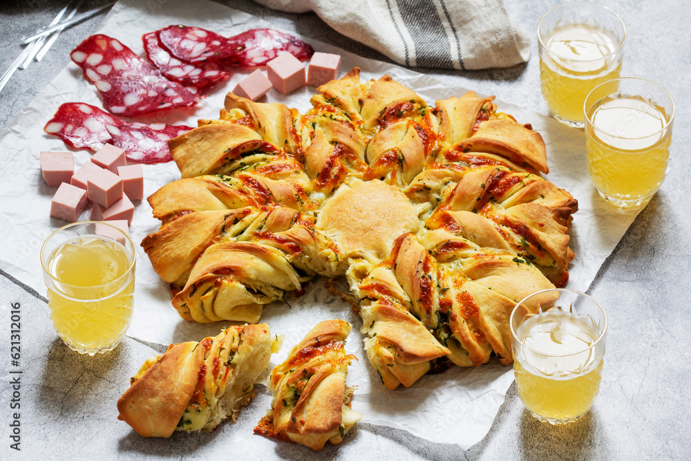 Table for a friendly party, snack star bread with cheese filling, sausage and beer.