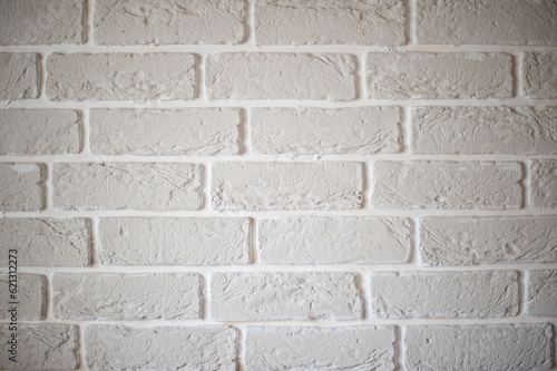 Part of the wall is made of decorative tiles in the form of white bricks.