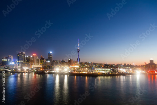 Night city of Auckland New Zealand. Glowing skyscrapers  bay and seaport of Auckland.