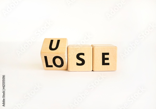 Use or lose symbol. Concept words Use or lose on wooden cubes. Businessman hand. Beautiful white table white background. Business Use or lose concept. Copy space.