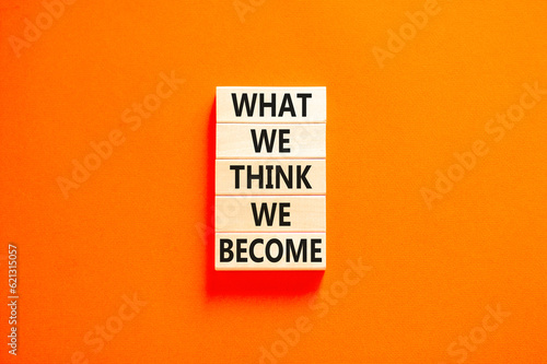 We become or think symbol. Concept word What we think We become on wooden block. Beautiful orange table orange background. Business we become or think concept. Copy space.