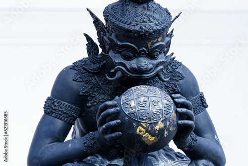 Phra Rahu the name of Thai and India god, The black giant eating the moon. Phra Rahu statue At Watpalalai photo