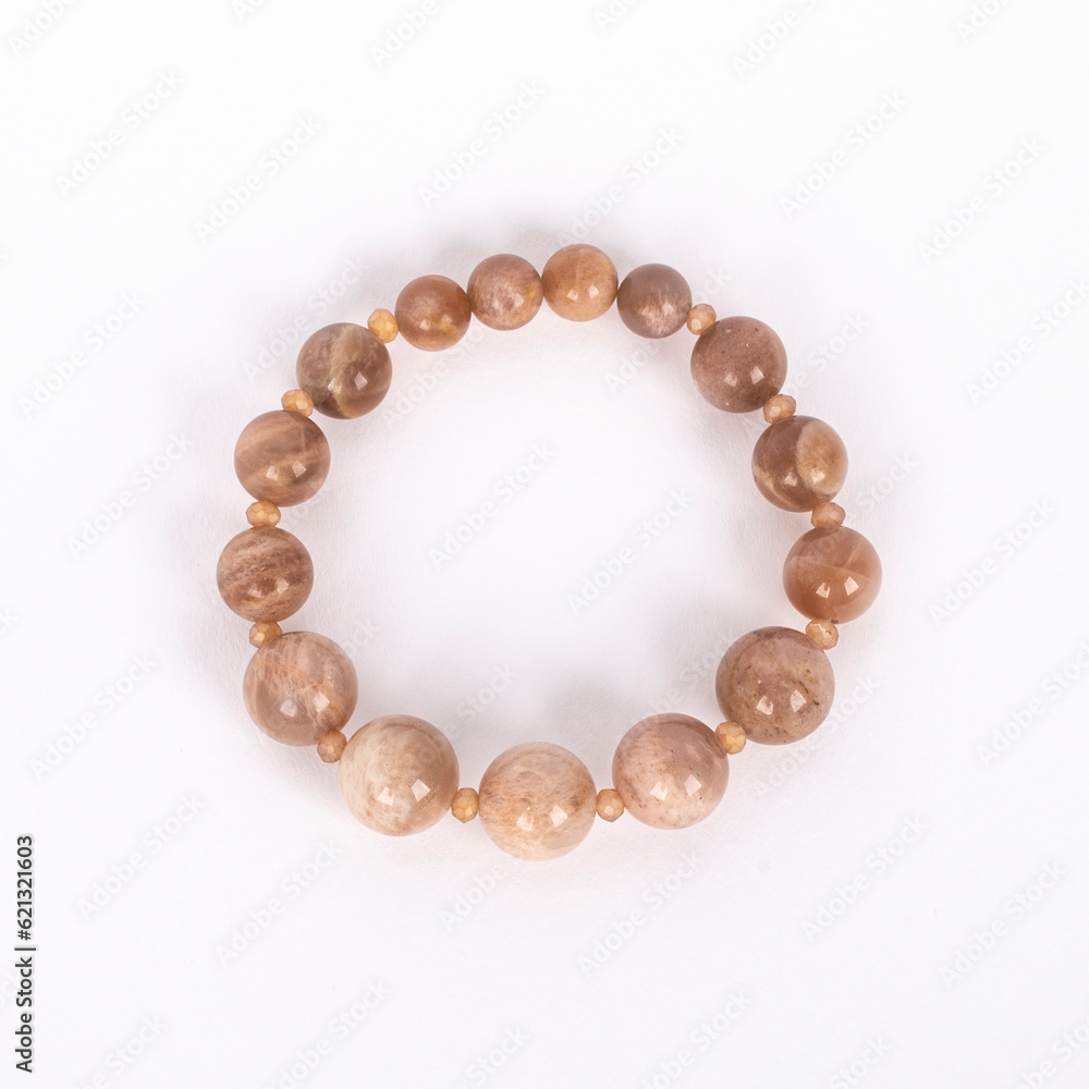 Beige natural stone, Sunstone bracelet. Three different sizes of the stones and small crystals between.