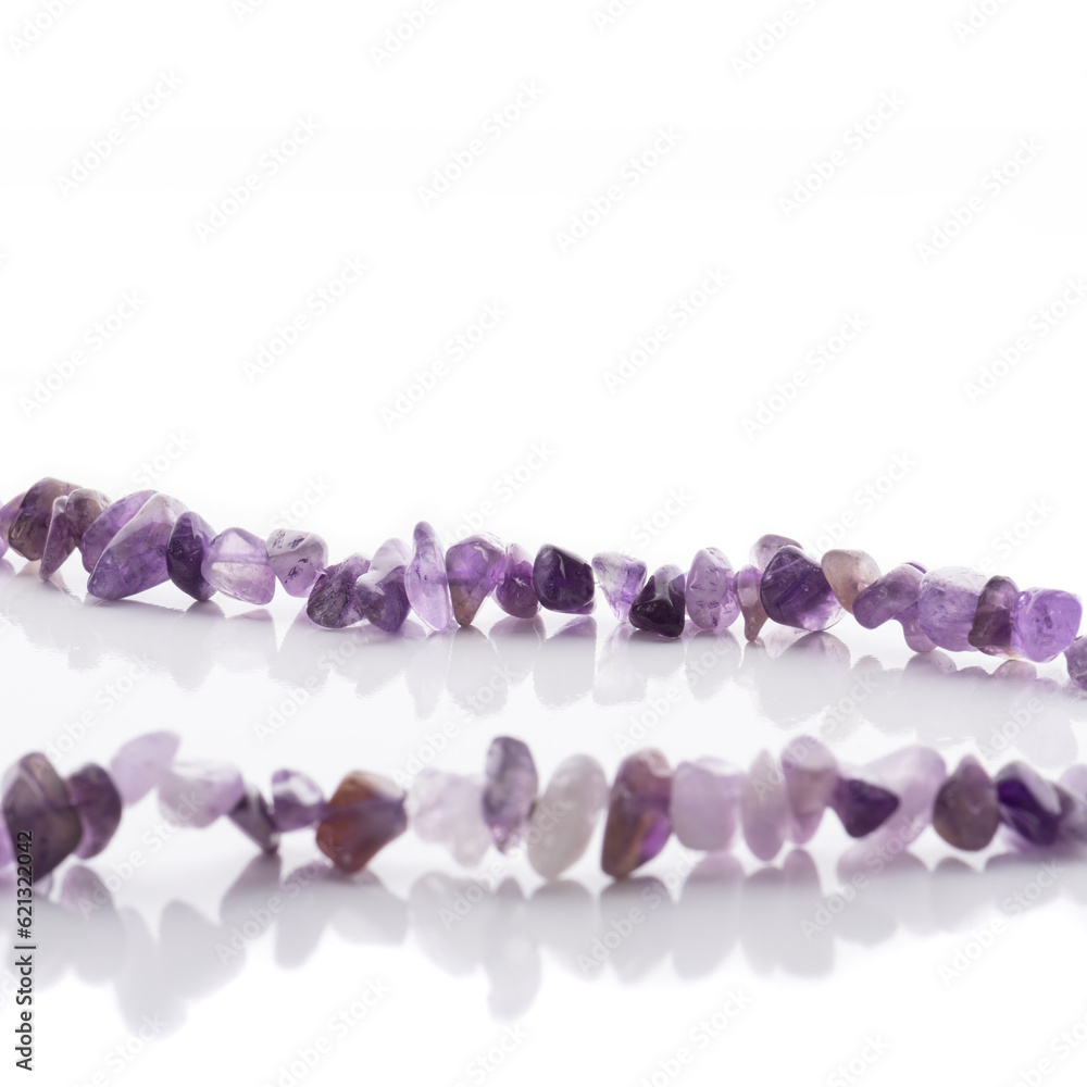 Strung amethyst natural stone strings on white background. Energy crystals. Healing gemstones. Birthstones.
