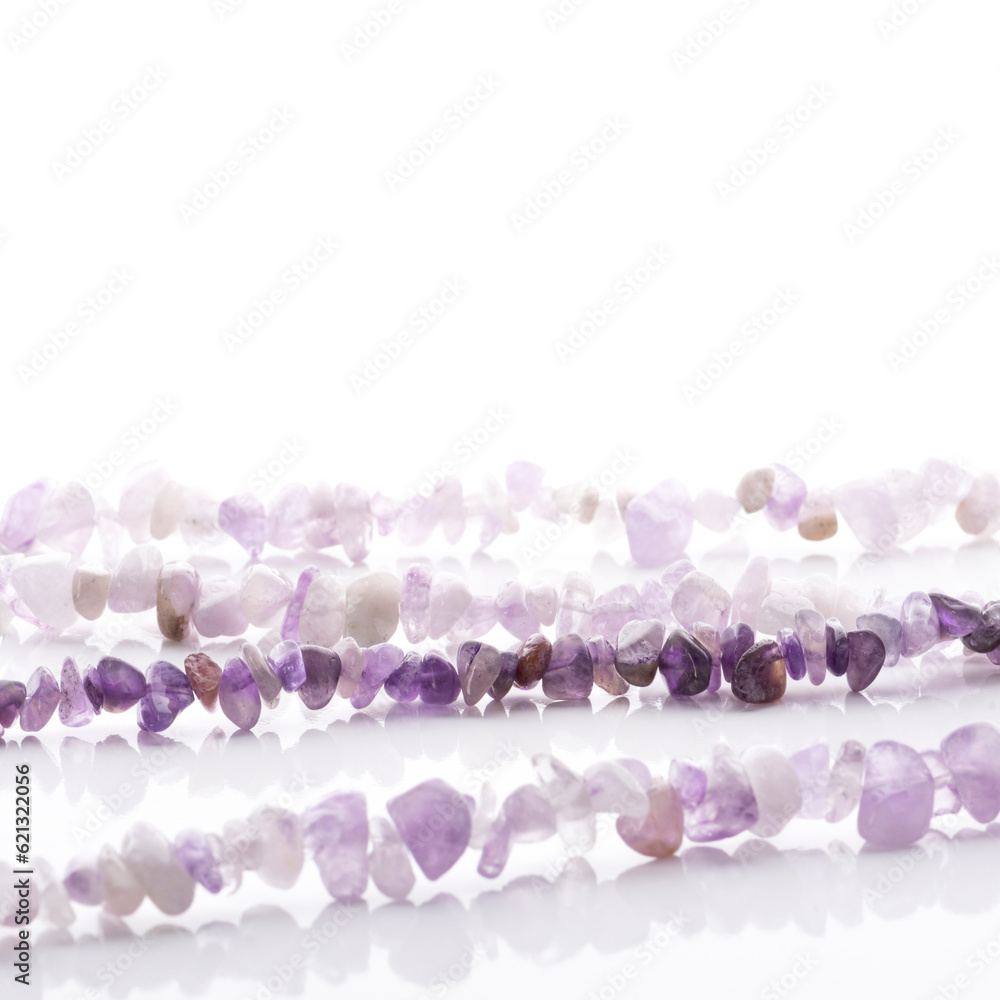 Strung amethyst natural stone strings on white background. Energy crystals. Healing gemstones. Birthstones.