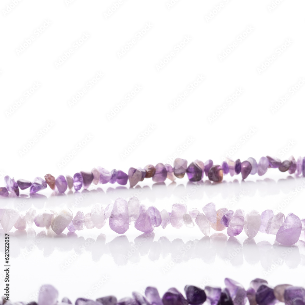 Strung amethyst natural stone strings on white background. Energy crystals. Healing gemstones. Birthstones.
