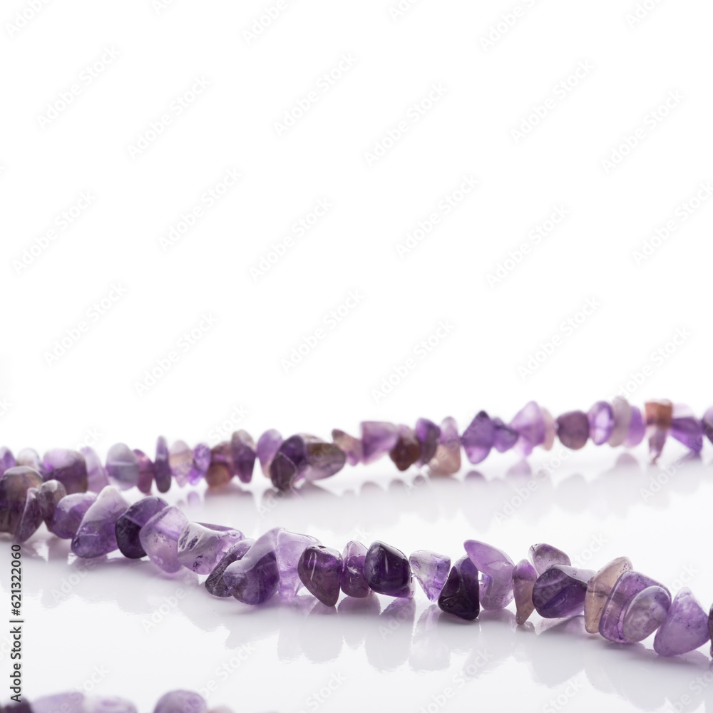 Strung amethyst natural stone strings on white background. Energy crystals. Healing gemstones. Birthstones.