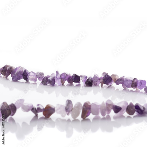 Obraz na płótnie Strung amethyst natural stone strings on white background. Energy crystals. Healing gemstones. Birthstones. w salonie