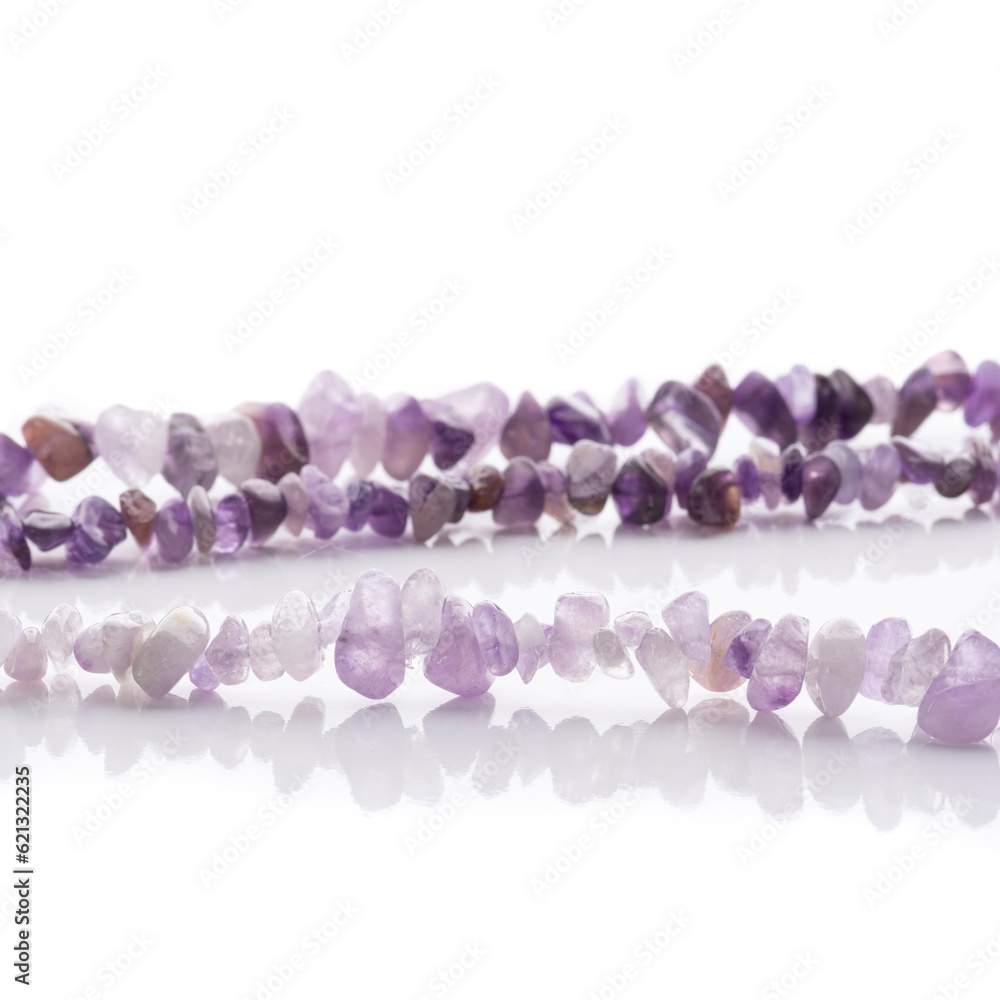 Strung amethyst natural stone strings on white background. Energy crystals. Healing gemstones. Birthstones.