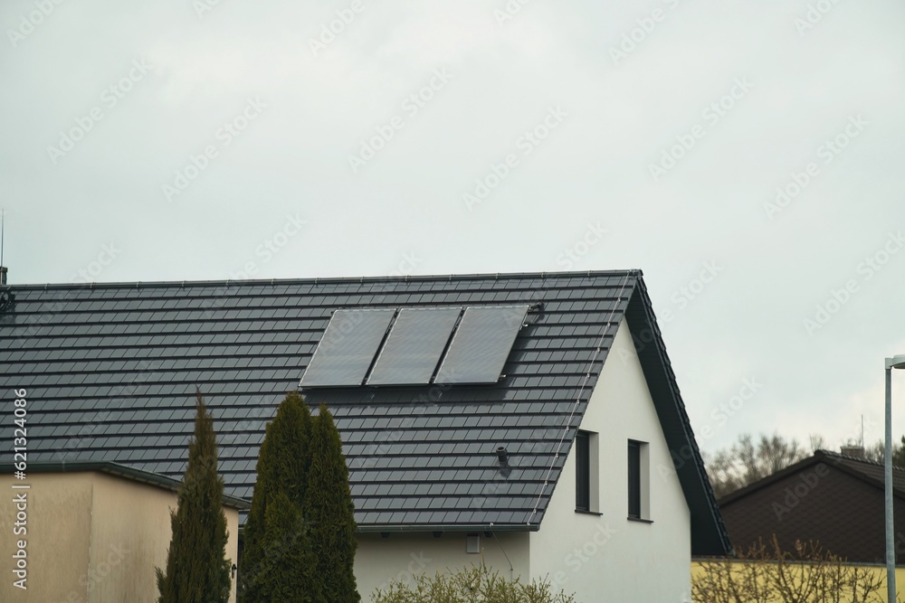 Foto de Water solar collector on a red metal roof. Solar thermal and ...