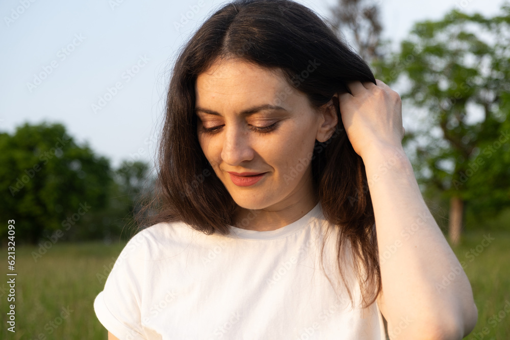 Dreamy pensive 35-year-old brunette woman in nature. The concept of unity with nature, feminine energy. Dreamy pensive 35-year-old brunette woman in nature. The concept of unity with nature, feminine energy.
