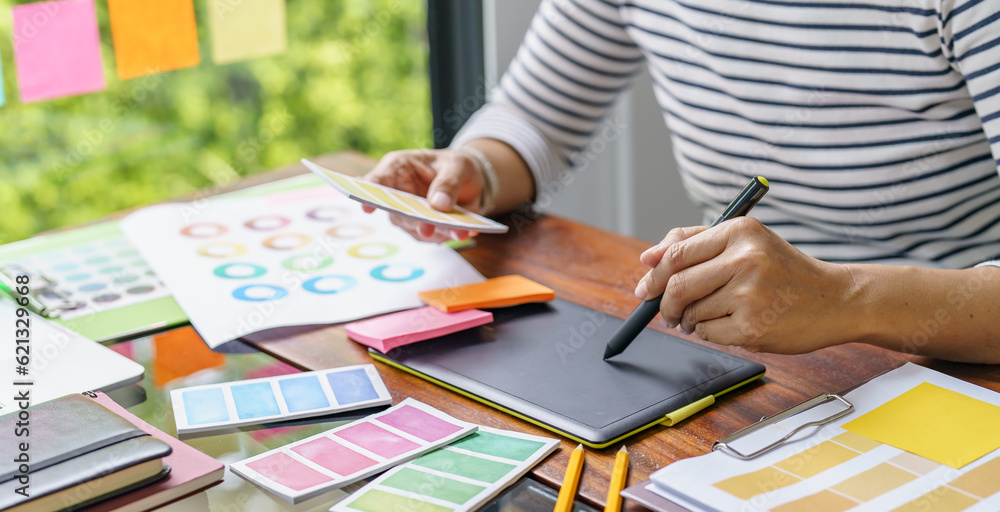 Teamwork brainstorming Creative idea Business project. Business People meeting taking notes while discussing with Color swatch samples to share idea Teamwork brainstorming Creative idea Business project. Business People meeting taking notes while discussing with Color swatch samples to share idea