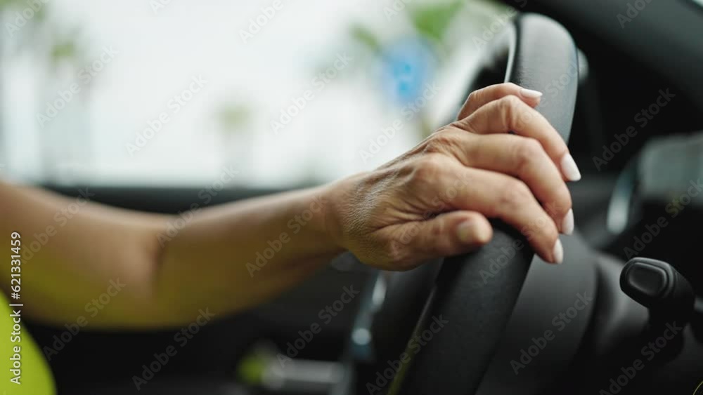 Middle age hispanic woman driving a car on the road Middle age hispanic woman driving a car on the road