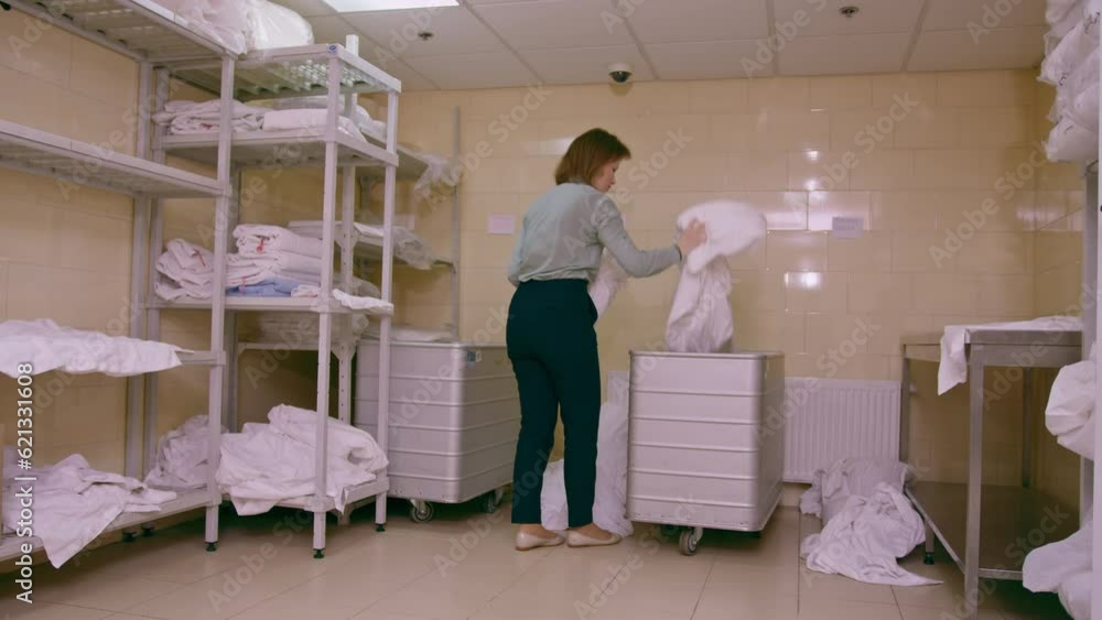 industrial laundry in a hotel dirty bed linen lies on the floor