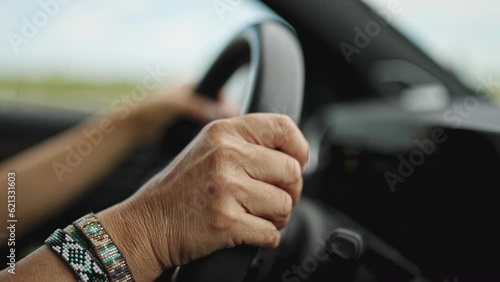 Wallpaper Mural Middle age hispanic woman driving a car on the road Torontodigital.ca