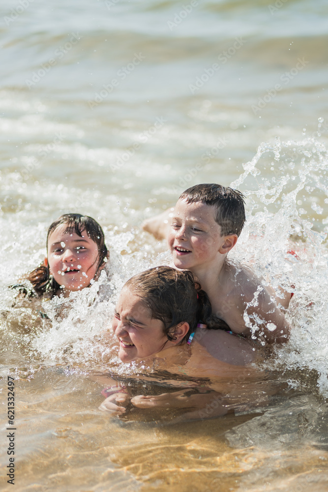 fun siblings on a day at the beach. they play as a family at the seashore. fun siblings on a day at the beach. they play as a family at the seashore.