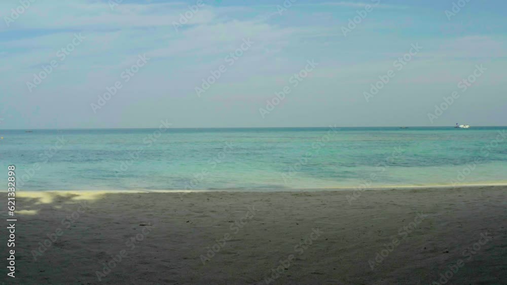 Aerial video of a drone flying over a picturesque beach with white sand and blue water, palm trees and sea waves. Aerial video of a drone flying over a picturesque beach with white sand and blue water, palm trees and sea waves.