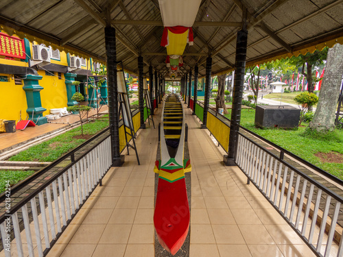 Jakarta, Indonesia (July 8, 2023): The traditional South Sumatran Dragon Boat sits on a pavilion in Taman Mini Indonesia Indah. photo