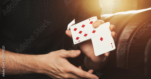 Close up of gambler guy clever hands of magician shuffling gambling cards. Male showing perform playing cards. Concept of magic, casino, performance, circus, gambling, game, show. Copy ad text space