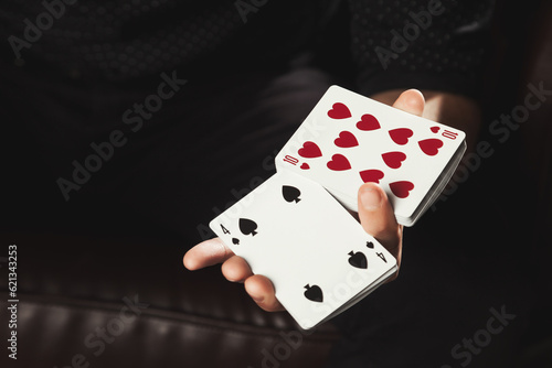 Close-up of clever hands gambler male with gambling cards. Man magician showing perform trick of playing cards. Concept of magic, casino, performance, circus, gambling, game, show. Copy ad text space