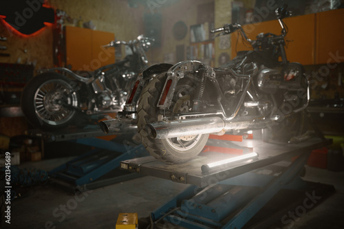 Motorcycles standing on lift machine at vintage repair shop