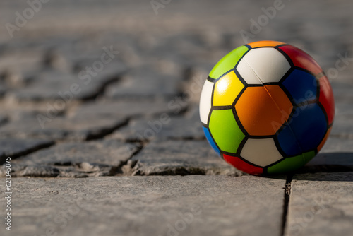 Fototapeta Naklejka Na Ścianę i Meble -  a small colorful childrens ball on a street