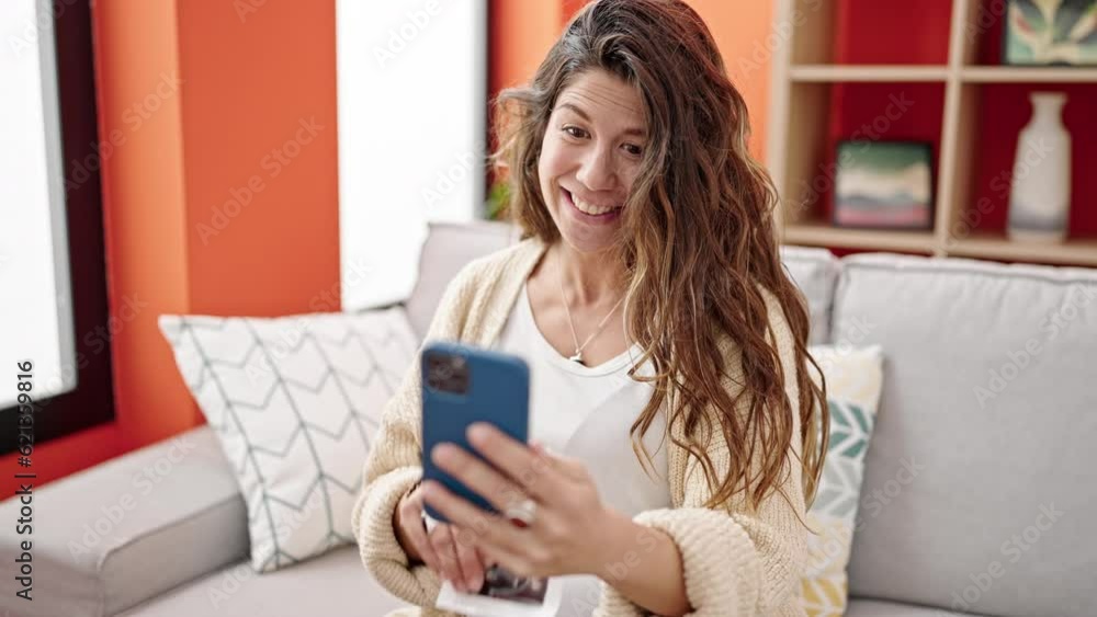 Young pregnant woman having video call showing baby ultrasound at home Young pregnant woman having video call showing baby ultrasound at home