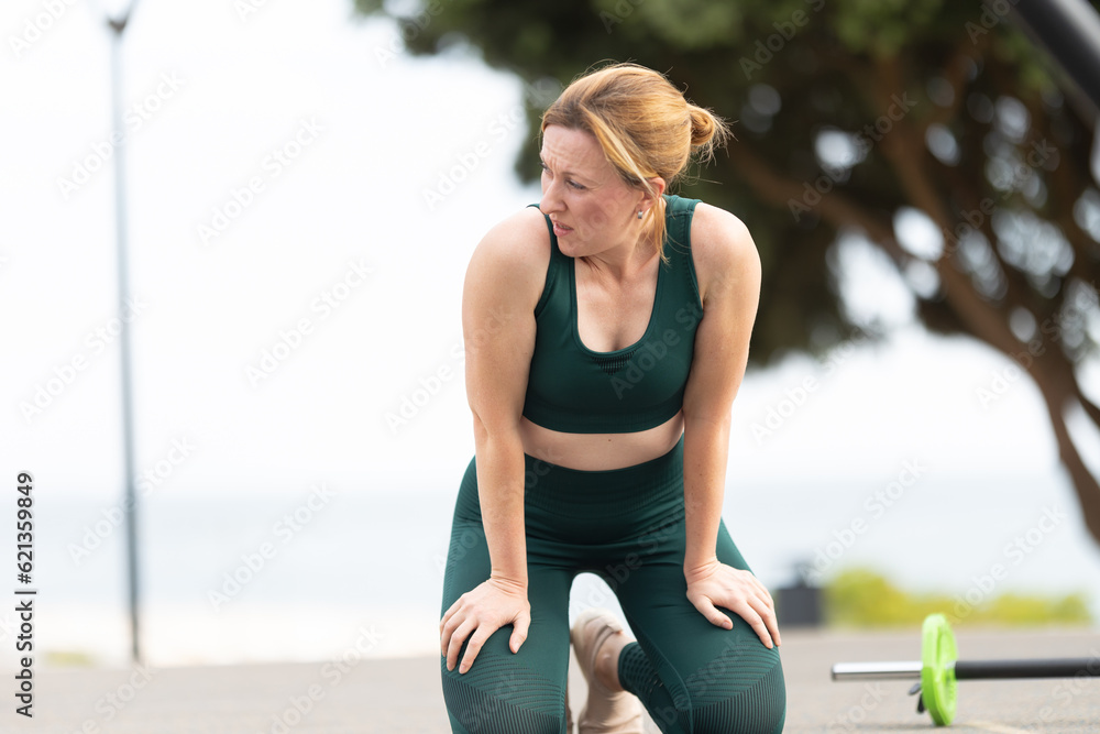 Adult sportive woman with no make up doing fitness outdoors