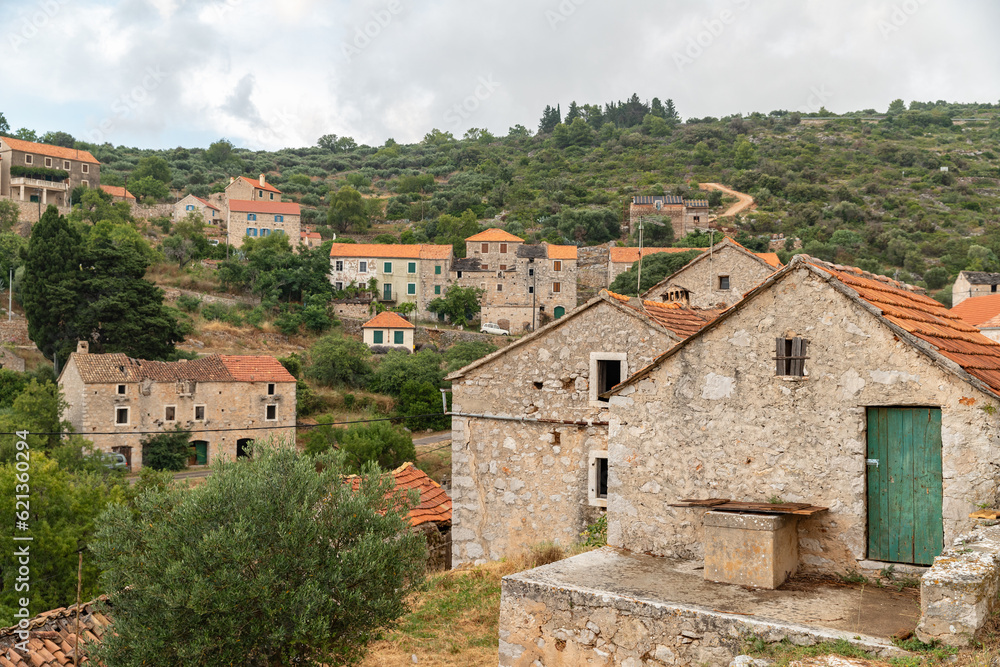 Stone houses and bell tower of the village Velo Grablje on Island Hvar in Croatia, founded in the 14th century. 