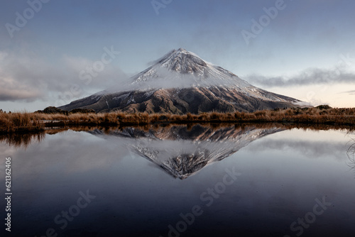 Mount Egmont, also called Mt Taranaki on the north Island of New Zealand during sunset with a beautiful reflection in the water of a little lake © Sven Taubert