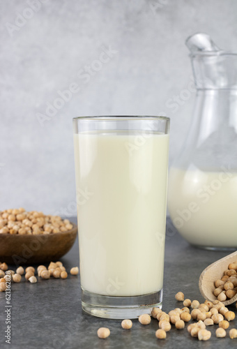 Chickpea milk with chickpeas on a gray background. Lactose free milk. Alternative dairy product.