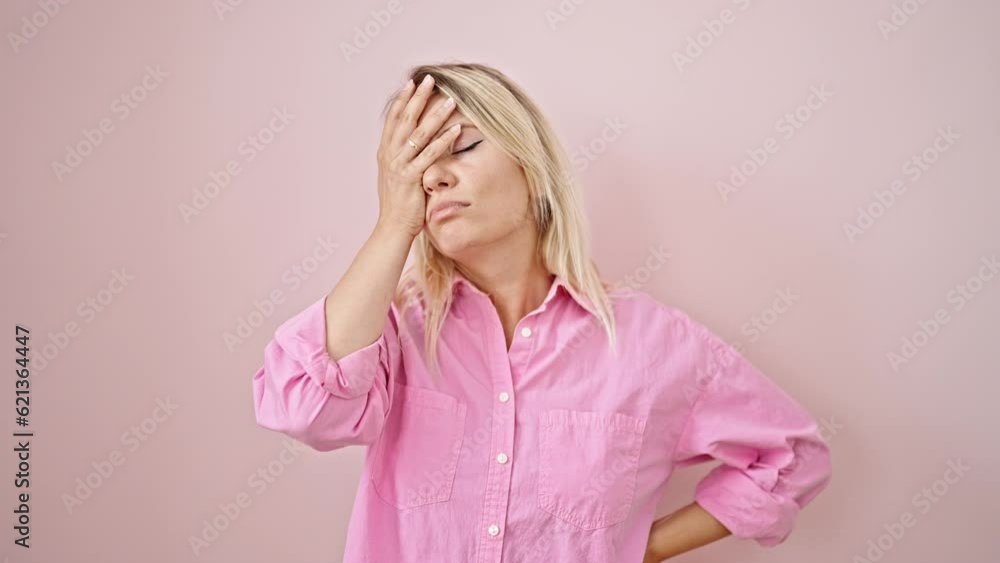 Young blonde woman stressed standing over isolated pink background Young blonde woman stressed standing over isolated pink background