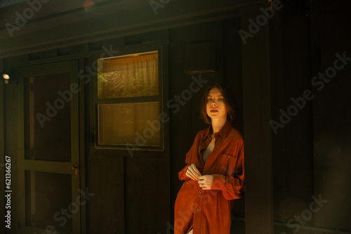 Woman Standing In Front Of Cabin